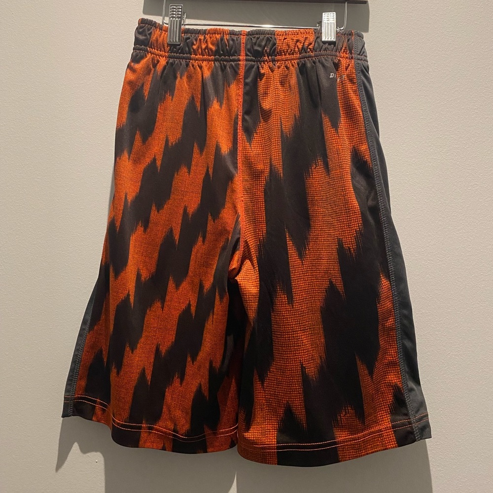 Nike Dry Fit Youth size medium gym shorts. Black and orange
